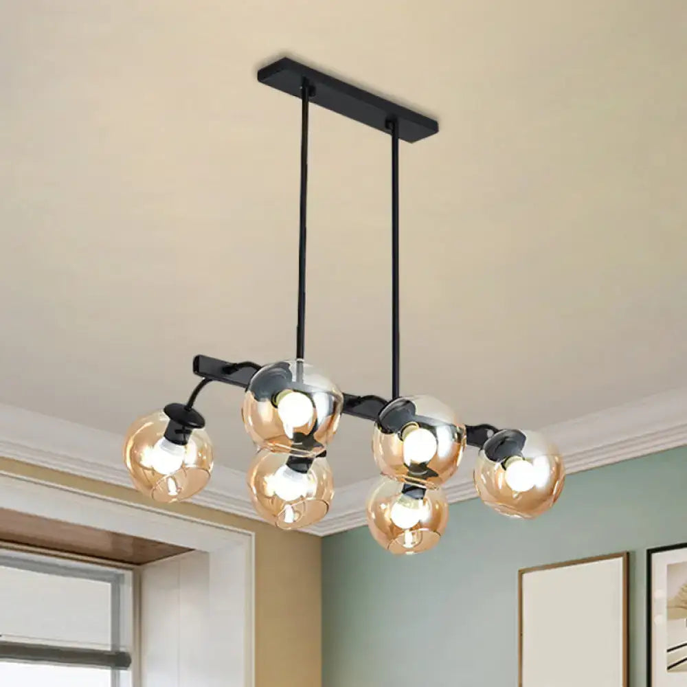 Modern black metal chandelier with five amber-tinted glass globe bulbs featuring orb shade for kitchen and dining room
