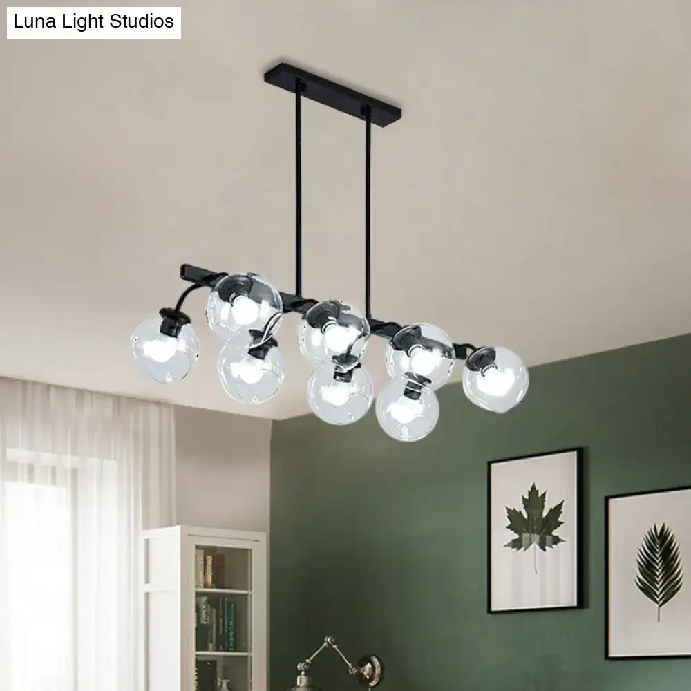 Black metal chandelier with clear glass globe bulbs and orb shade for modern kitchen and dining room lighting
