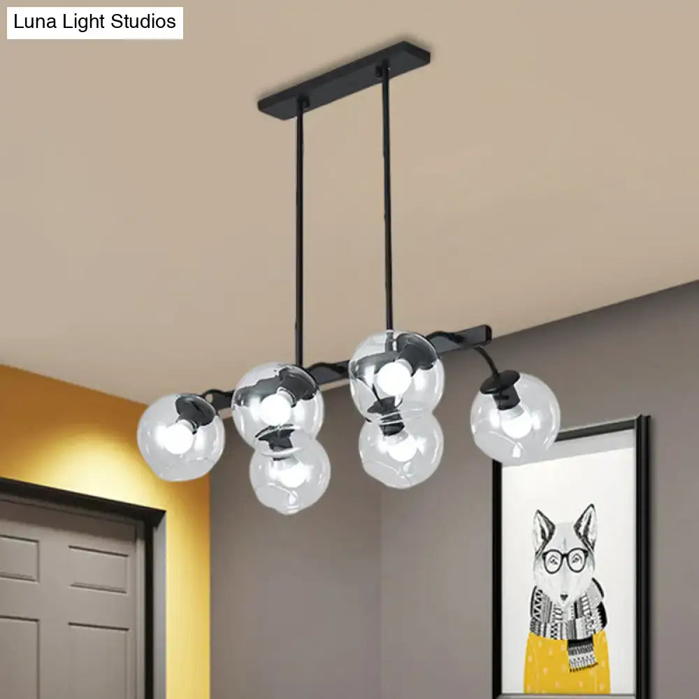 Modern black metal chandelier with five clear glass globe bulbs featuring a black orb shade for kitchen and dining room