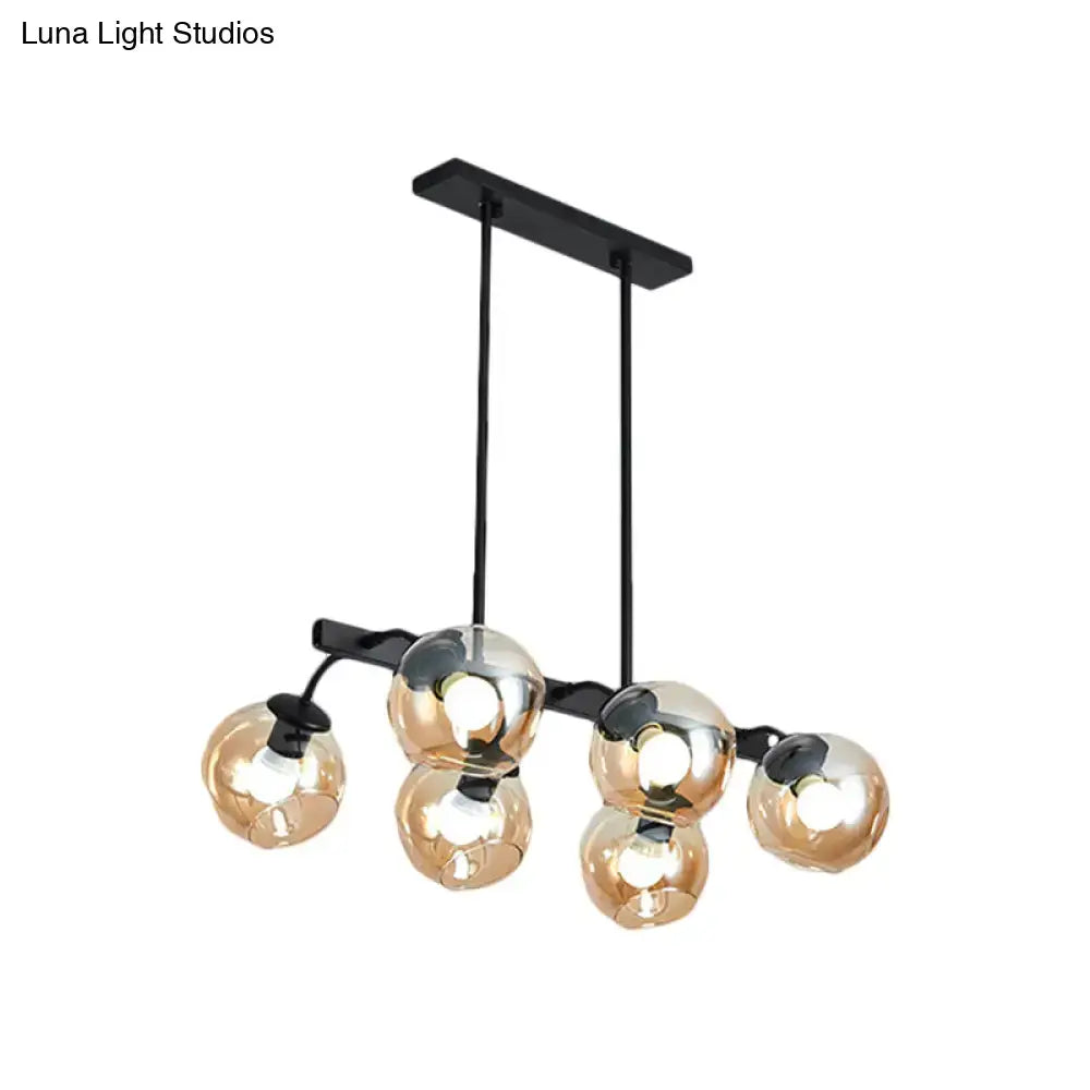 Modern black metal chandelier with five reflective amber glass globe shades featuring orb shade for kitchen use