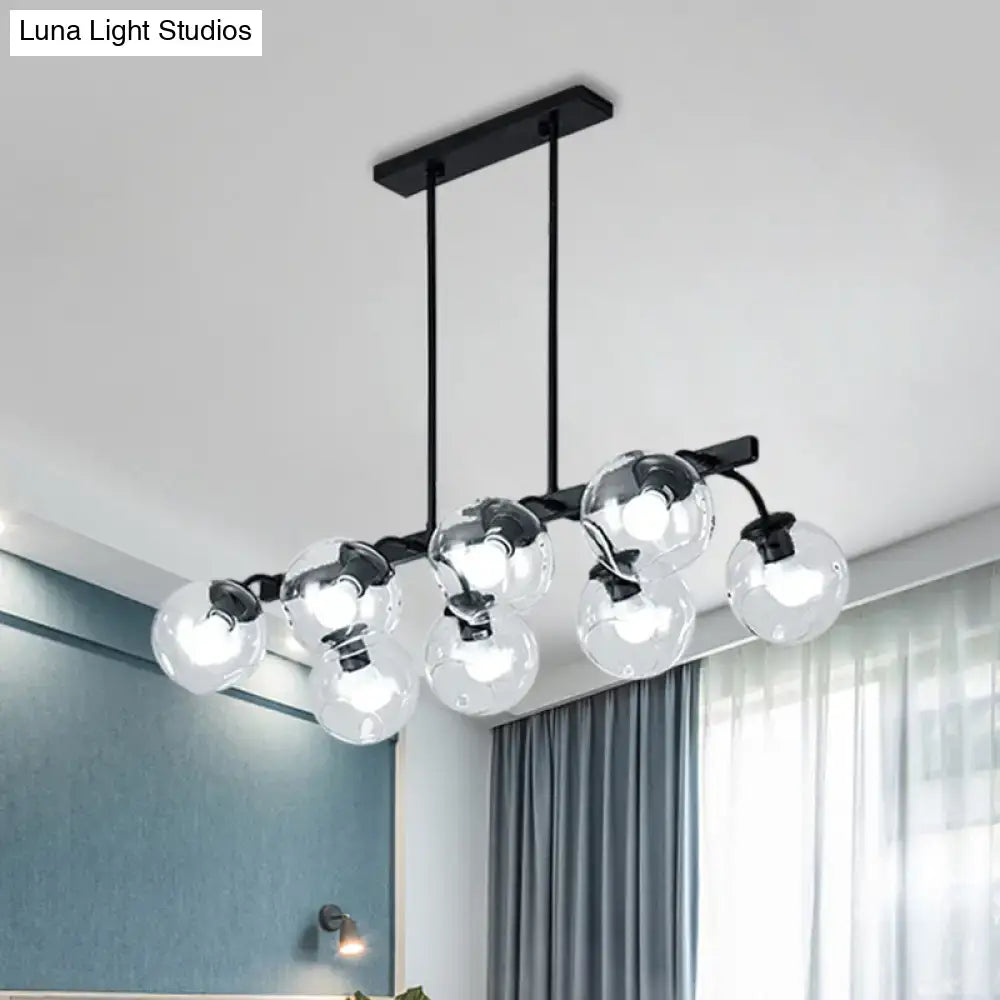 Modern black metal chandelier with clear glass globe bulbs featuring black orb shade for kitchen and dining room decor