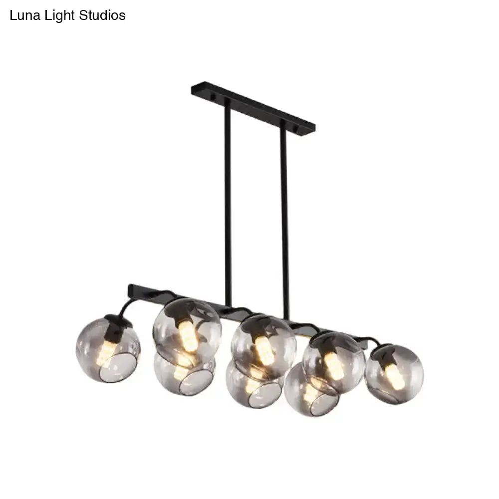 Black metal chandelier with six smoked glass globe orb shades for modern kitchen and dining room decor