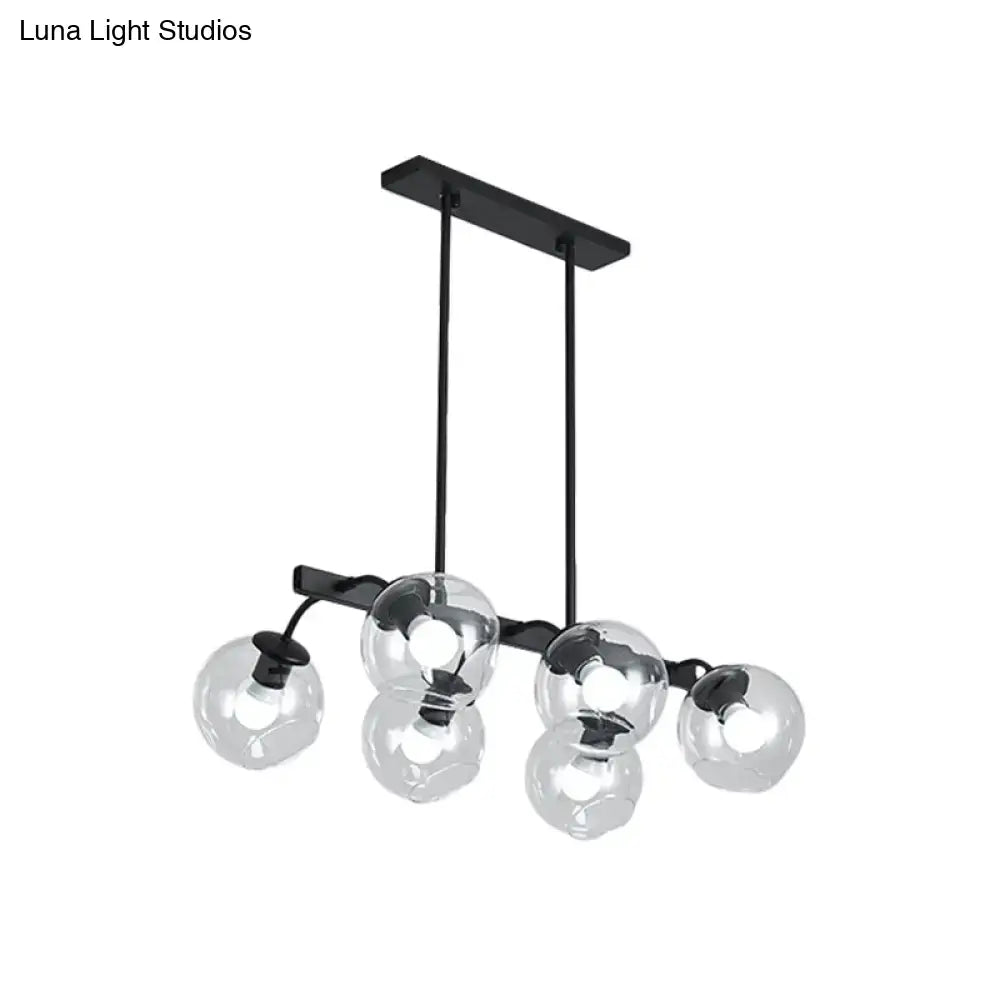 Black metal chandelier with five clear glass globe shades featuring a modern orb shade for kitchen and dining room