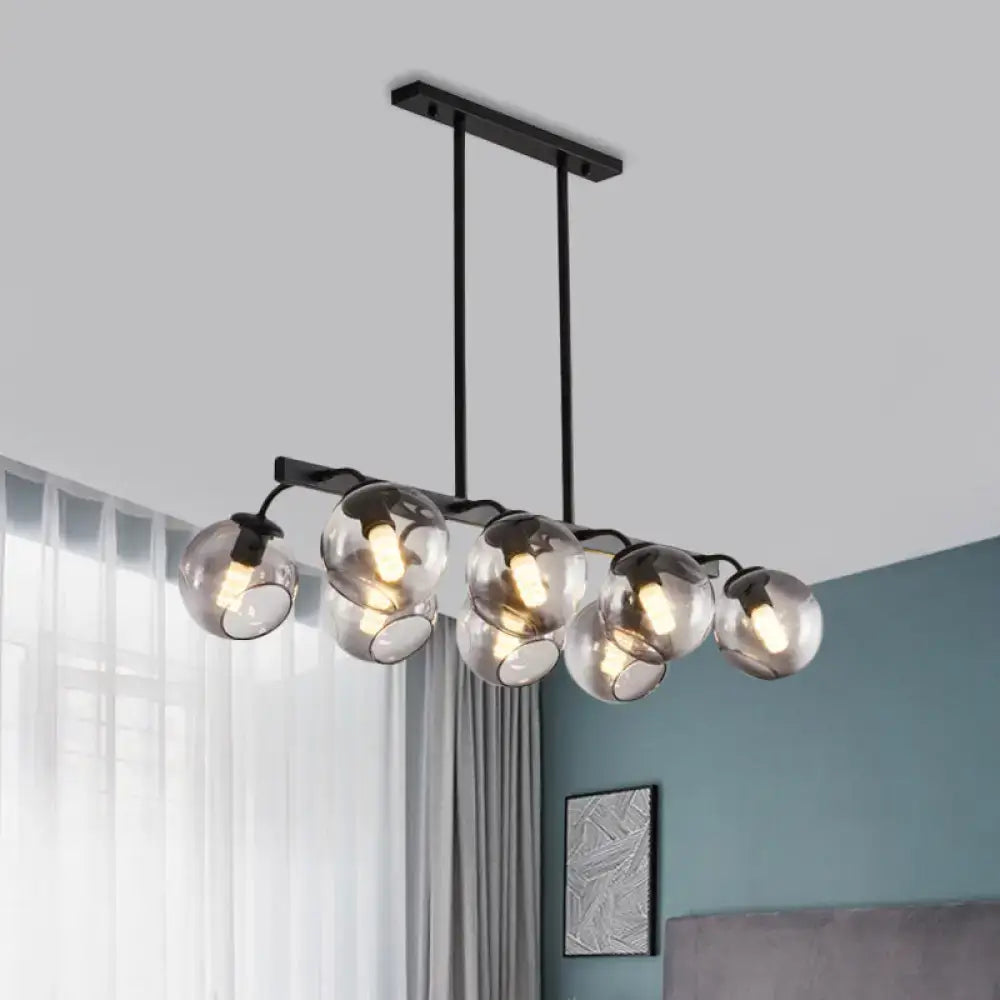 Modern black metal chandelier with five clear glass globes and orb shade for kitchen and dining room by DecorBites