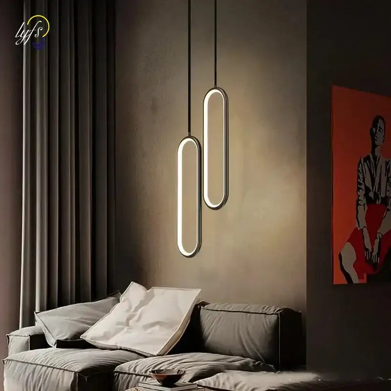Modern black oval pendant light with led bulbs and a warm glow designed for dining room lighting