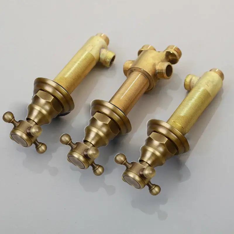Three vintage-style brass bathroom faucets with ornate cross handles and water control valve in black painting finish