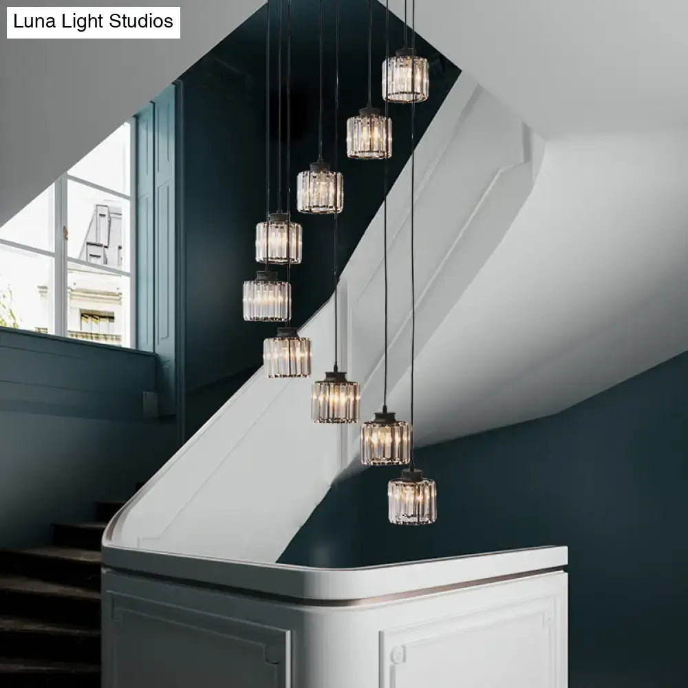 DecorBites™ modern prismatic crystal cylindrical pendant ceiling lights with dark metal fixtures hang above stairway