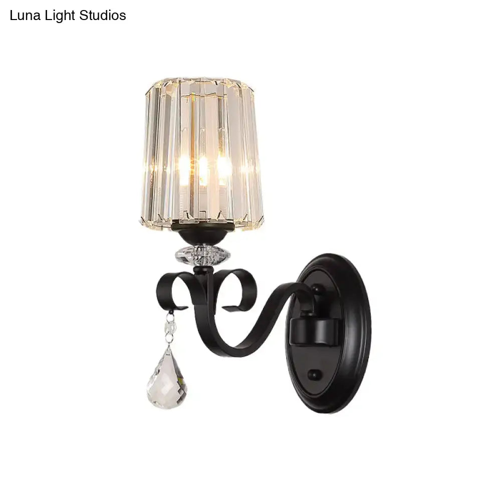 Elegant black wrought iron wall mount lamp with faceted crystal shade and teardrop pendant for living room
