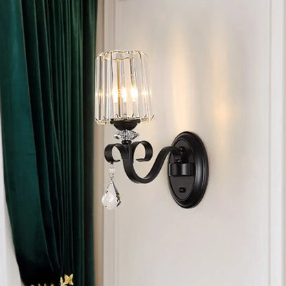 Modern black wrought iron wall mount lamp with prismatic crystal chandelier shade and dangling crystal droplet for living room