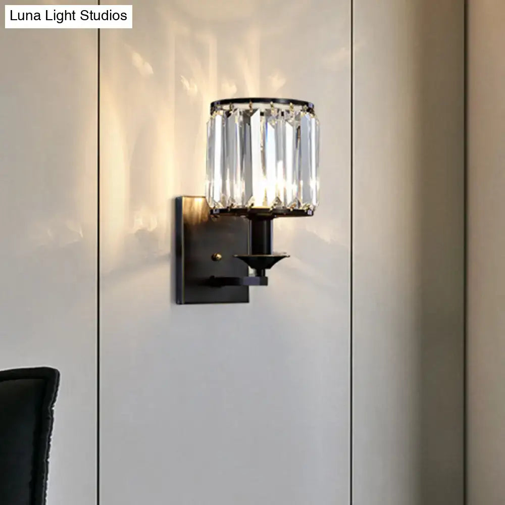 Modern black metal wall sconce with cylindrical prismatic crystal shade and e12 light type bulb base for bedroom use
