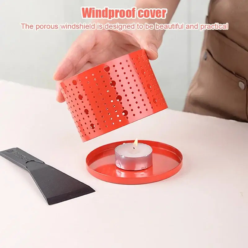 Red perforated metal windproof cover for candle included in modern black raclette fondue set with wooden lid grill
