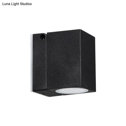Modern black rectangular mini textured wall sconce with circular white LED lens for outdoor maximum bulb wattage use