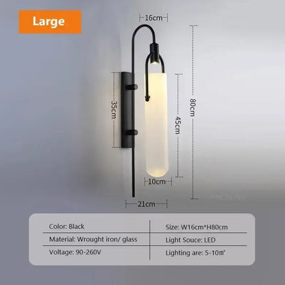 Modern black wrought iron wall lamp with curved arm and cylindrical frosted glass shade led bedroom sconce