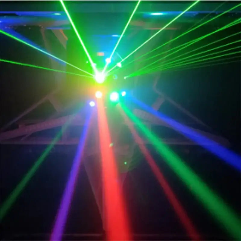 Modern black rgbw laser football moving head projecting vibrant green red and blue laser beams in a dark party room
