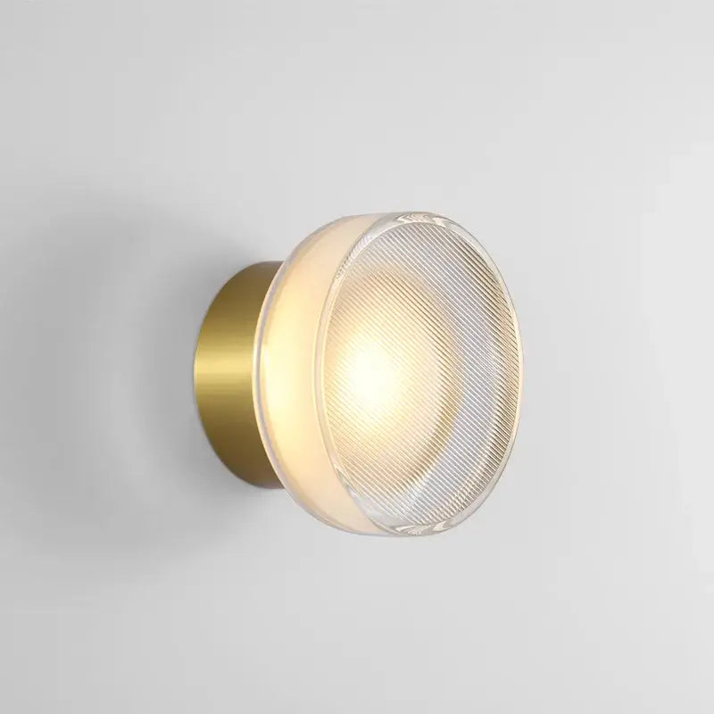 Modern black wall sconce with brass finish and frosted ribbed glass diffuser for decorbites elegant glass led lighting
