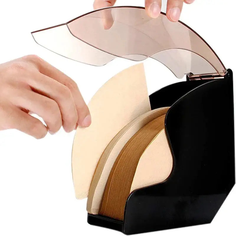 Modern black and rose gold wave coffee filter dispenser with black plastic organizer holding beige and brown coffee filters