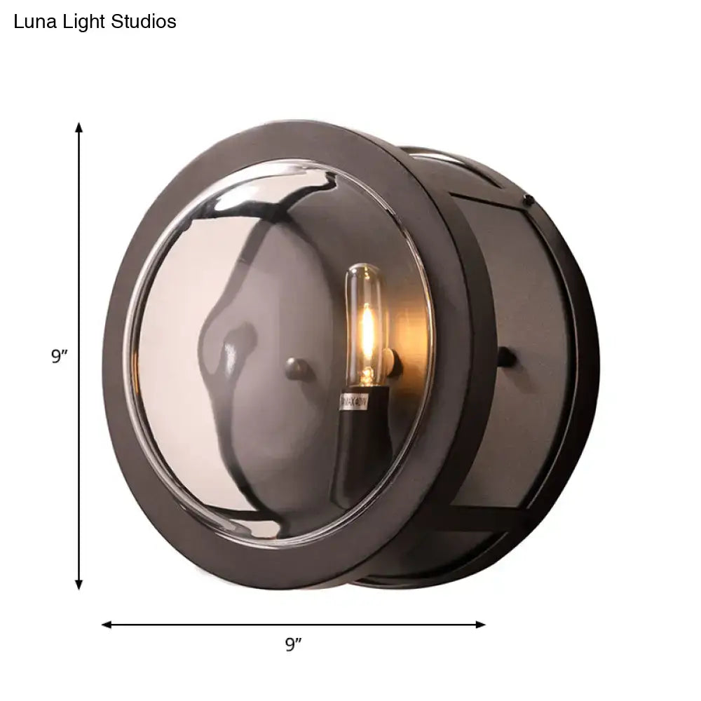 Modern black metal wall sconce with smoked glass lens and e12 bulb base for hallway lighting