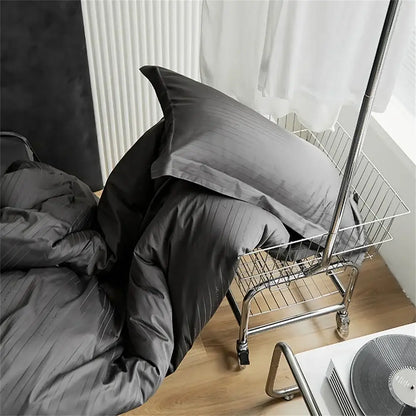 Modern black satin jacquard duvet cover set with dark gray striped duvet cover and pillow set in a wire shopping cart