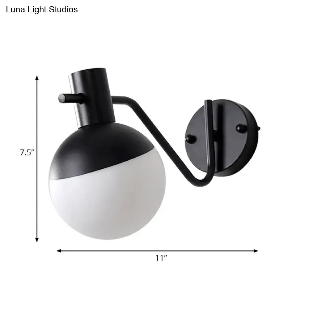 Modern black sconce light with global milk glass shade featuring a two-toned spherical design for living room