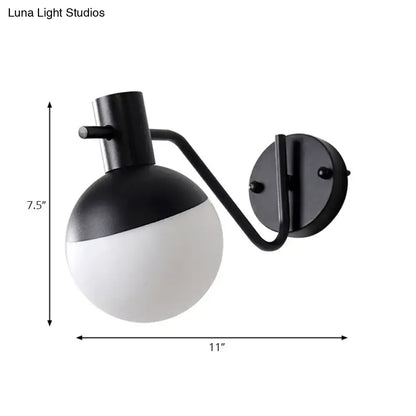 Modern black sconce light with global milk glass shade featuring a two-toned spherical design for living room
