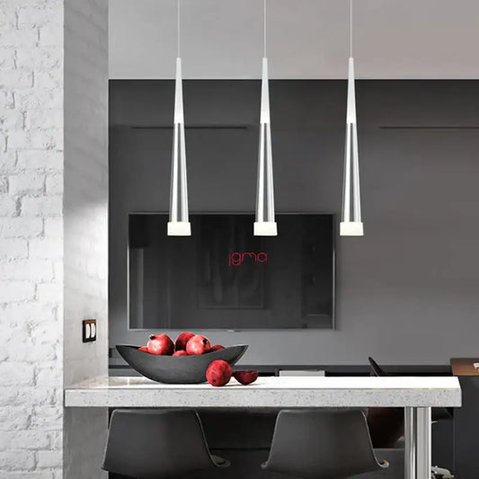 Three modern black and silver conical tube pendant lights by decorbites hang over a kitchen island