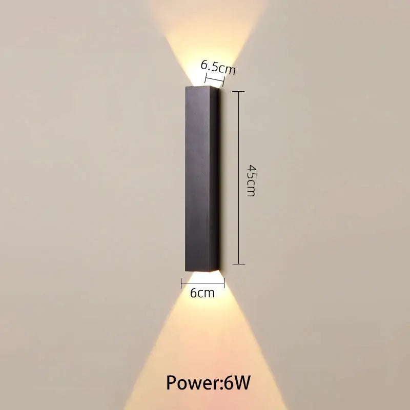 Modern black and silver led wall lamp with sleek rectangular design and warm up and down light sources for bedroom