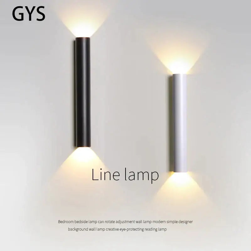 Modern black and silver led wall lamp with cylindrical design providing warm up and down light sources for bedrooms