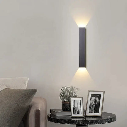 Modern black and silver led wall lamp with rectangular design and warm up and down light beams for bedroom use