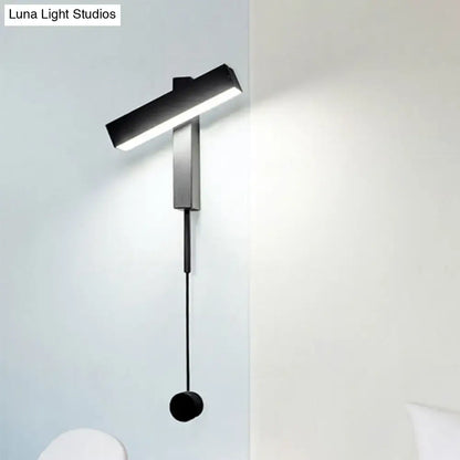 Modern black and silver wall lamp with adjustable arm and bulb base designed for bedroom use with minimalist LED sconce design
