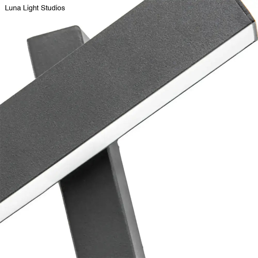 Modern black and white led table lamp with a sleek minimalist design featuring an adjustable arm and bulb base