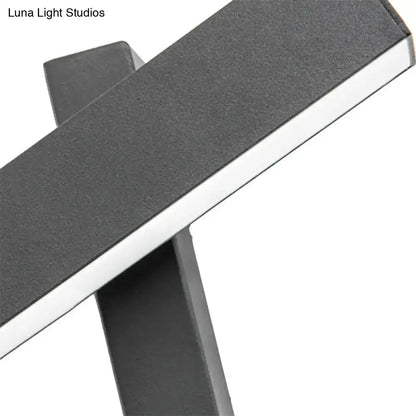 Modern black and white led table lamp with a sleek minimalist design featuring an adjustable arm and bulb base