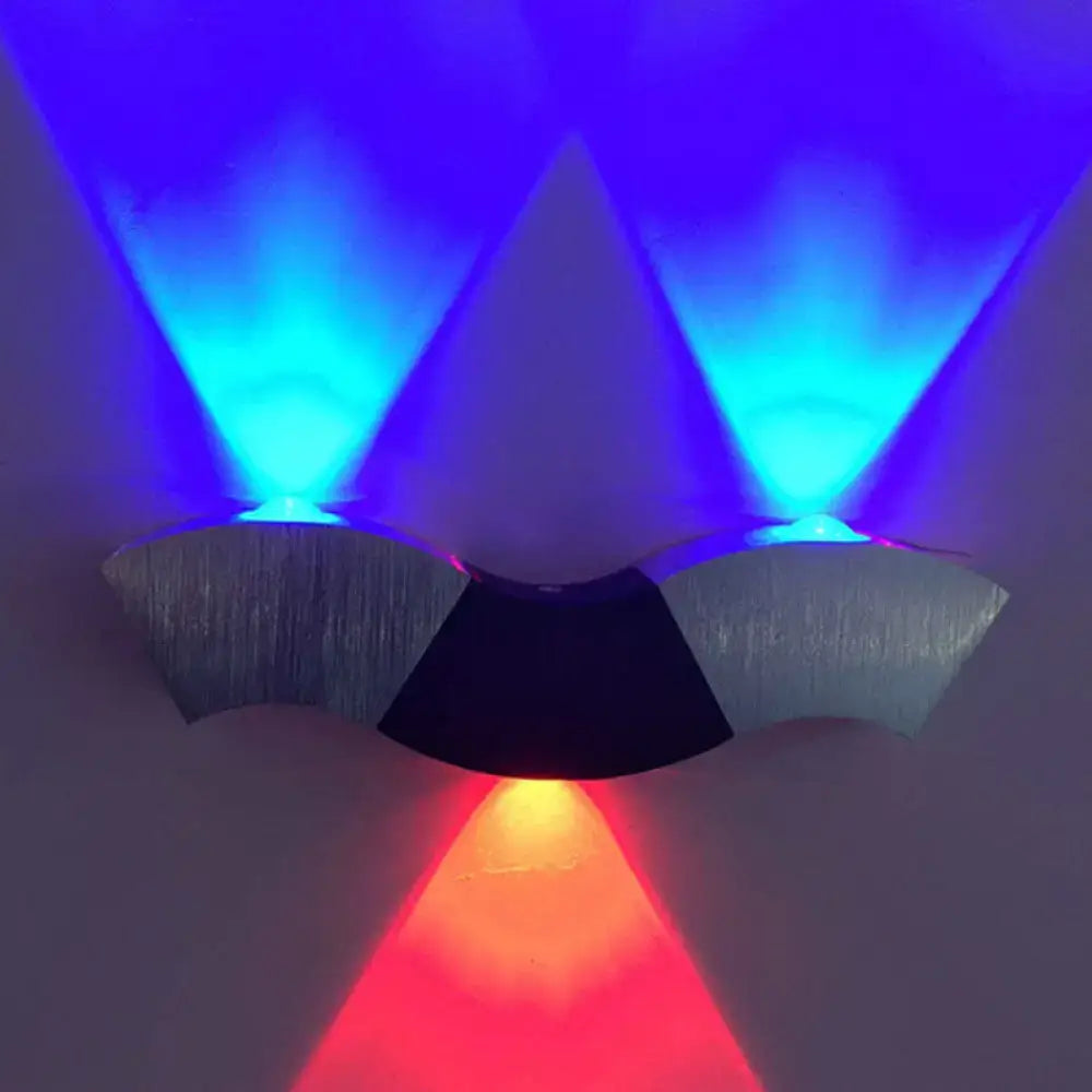 Modern black and silver led wall sconce with brushed metal finish and 10in fixture width emitting blue and red light beams