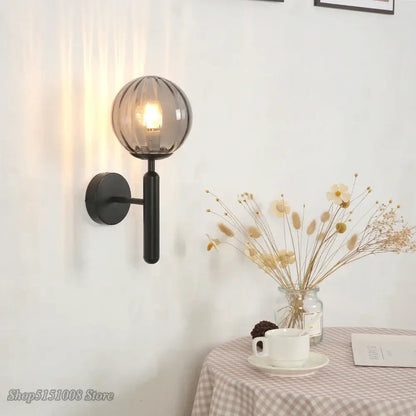Modern black wall lamp with a decorbites glass ball led and textured smoked glass globe for bedroom sconce lighting