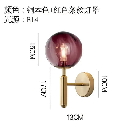 Modern black smoked glass ball led wall lamp with amber-tinted glass ball and brass-finished arm for bedroom decorbites