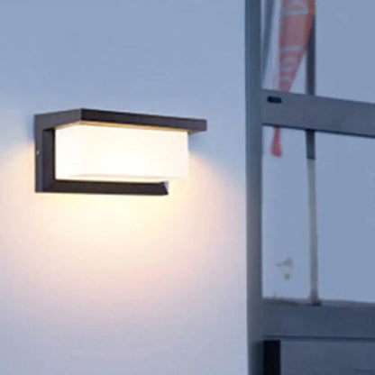 Modern black sound activated wall sconce with rectangular frosted glass diffuser emitting warm light for 220v-240v use