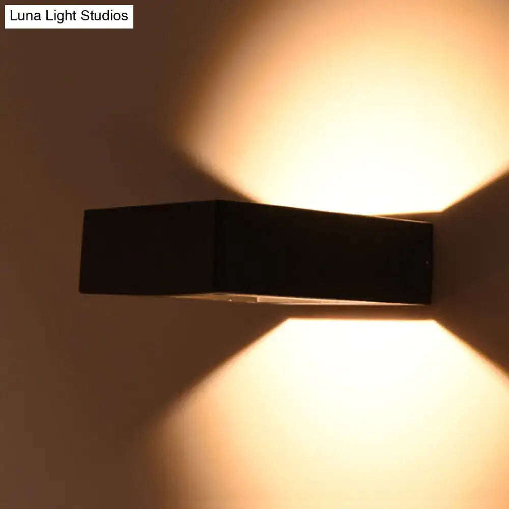 Modern black square led sconce light fixture emitting a warm ambient glow for porch lighting needs
