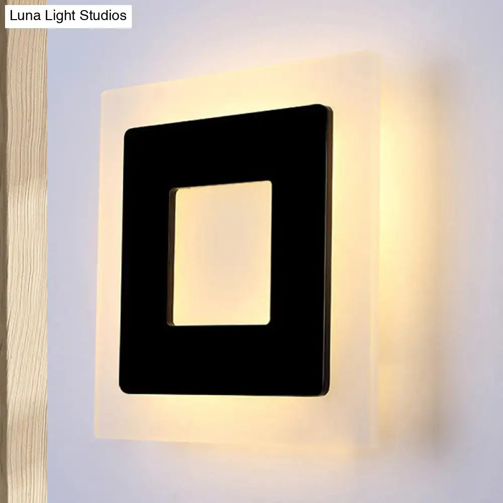 Modern black square sconce light with glowing warm light backlight ideal for bedroom lighting