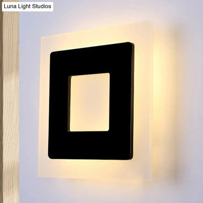 Modern black square sconce light with glowing warm light backlight ideal for bedroom lighting