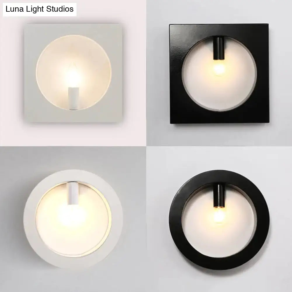 Modern black square wall sconce lamp with frosted glass light and cylindrical fixture in matte black and white finishes