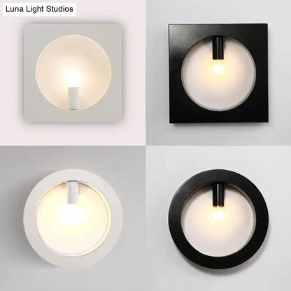 Modern black square wall sconce lamp with frosted glass light and cylindrical fixture in matte black and white finishes