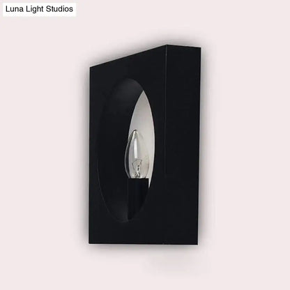 Modern black square wall sconce lamp with frosted glass and oval cutout framing bulb for bathroom lighting