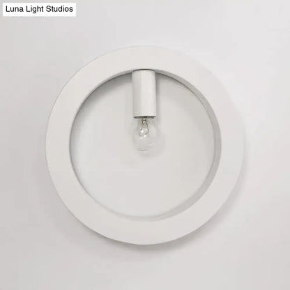 Modern black square wall sconce lamp with white circular frosted glass light fixture and central bulb for bathroom use