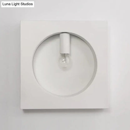 Minimalist white wall sconce lamp with circular recess and exposed bulb designed for modern bathroom lighting