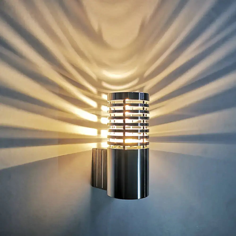 Modern black stacked ring wall lamp kit with sleek chrome finish and horizontal slats casting striped light patterns