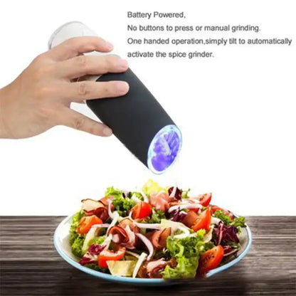 Modern black and stainless steel electric salt pepper grinder with glowing blue circular opening and battery-powered design