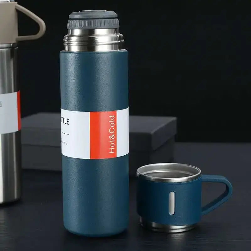 Teal vacuum insulated water bottle with stainless steel lid and base featuring hot and cold label in modern kitchen gift set