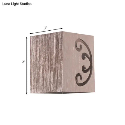 Modern black swirl led wall lamp featuring a square rustic wooden box with elegant scrollwork cutout for bedroom use