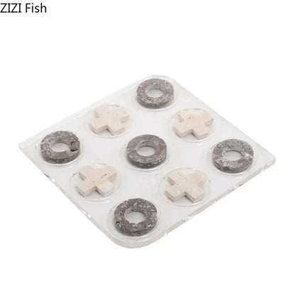 Set of nine gray and off-white stone-like pieces on clear tray in decorbites acrylic tic-tac-toe chessboard set