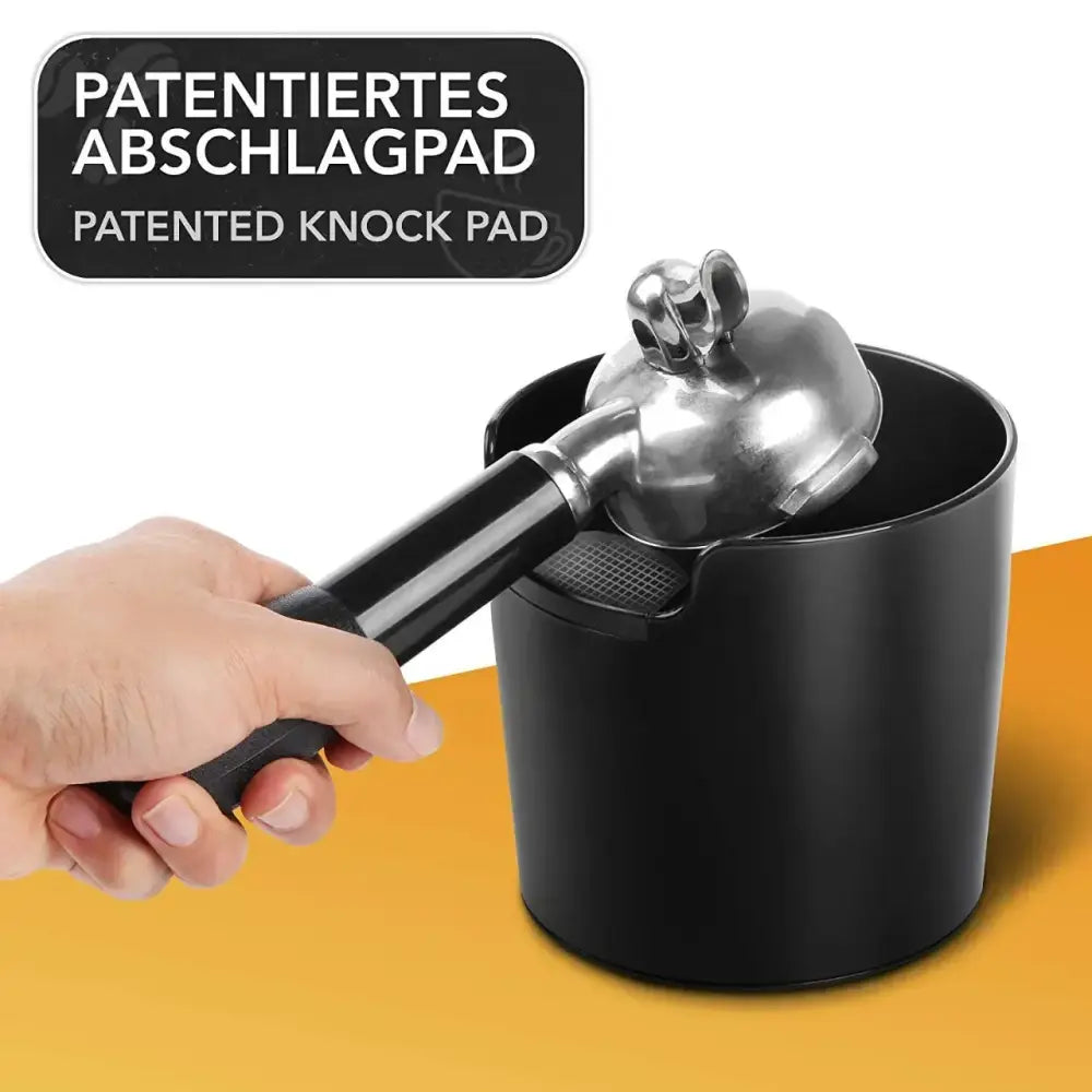 Modern black cylindrical coffee knock box dump bin with patent label and textured grip for decorbites coffee knock use