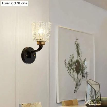 Modern black textured glass conical wall lighting bedroom sconce with brass accents and warm diffused light